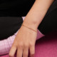 Cintilar gold-plated adjustable bracelet with pink in cross shape cover