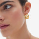 Sincerely gold-plated wide hoop earring with heart silhouette cover