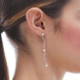 Milan rhodium-plated waves shape long earrings with pearls cover