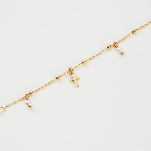Tobillera cruz color perla bañada en oro